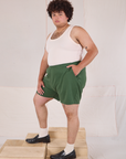 Side view of Easy Shorts in Dark Emerald Green and Tank Top in vintage tee off-white on Miguel
