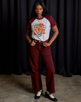 Kandia is wearing Raglan Tee in Clown paired with red wine Mid-Rise Work Pants
