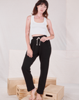 Alex is wearing Rolled Cuff Sweat Pants in Basic Black and Cropped Tank in vintage tee off-white