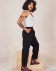 Side view of Heavyweight Trousers in Basic Black and Cropped Tank Top in vintage tee off-white worn by Jesse