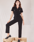 Alex is wearing Heritage Short Sleeve Jumpsuit in Basic Black