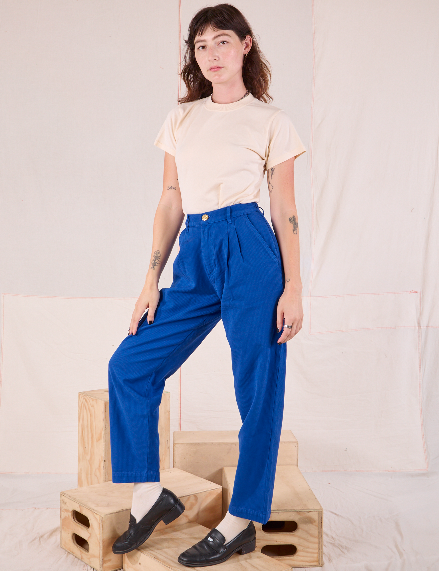 Angled front view of Heritage Trousers in Royal Blue and Organic Vintage Tee in vintage tee off-white