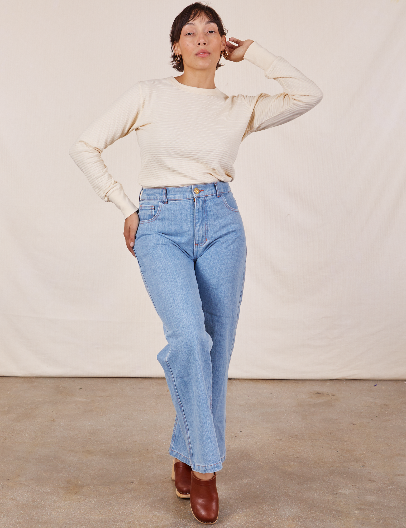 Tiara is wearing Honeycomb Thermal in Vintage Tee Off-White tucked into light wash Sailor Jeans