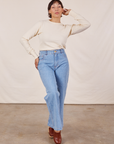Tiara is wearing Honeycomb Thermal in Vintage Off-White tucked into light wash Sailor Jeans