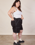 Side view of Carpenter Shorts in Basic Black and Cropped Tank in vintage tee off-white on Ashley