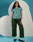 Shahana is wearing Angel Print Pantry Button-Up and evergreen Drop Pocket Cargo Pants