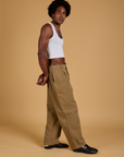 Side view of Baggy Mid-Rise Trousers in Desert Brown and vintage tee-white Cropped Tank