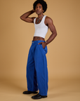 Side view of Baggy Mid-Rise Trousers in Royal Blue and vintage tee white Cropped Tank on Jerrod