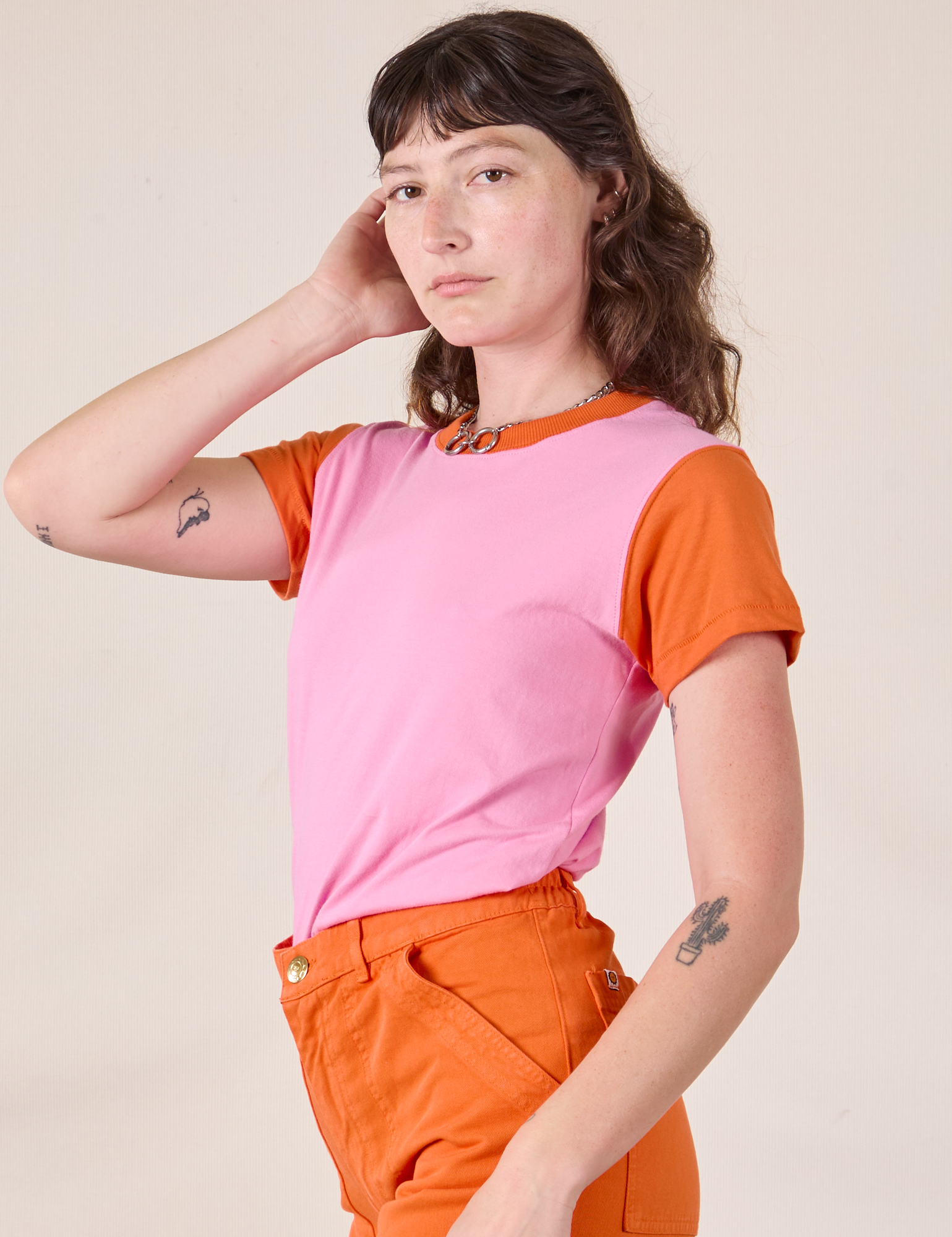 Angled view of Mismatched Tee in Pink & Orange on Alex