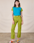 Alex is wearing Mismatched Tee in Blue & Green and gross green Work Pants