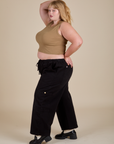 Side view of Muscle Tee in Desert Brown and black Drop Pocket Cargo Pants on Juliet