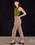 Side view of Work Pants in Autumn Stripe and summer olive Racerback Tank on Alex
