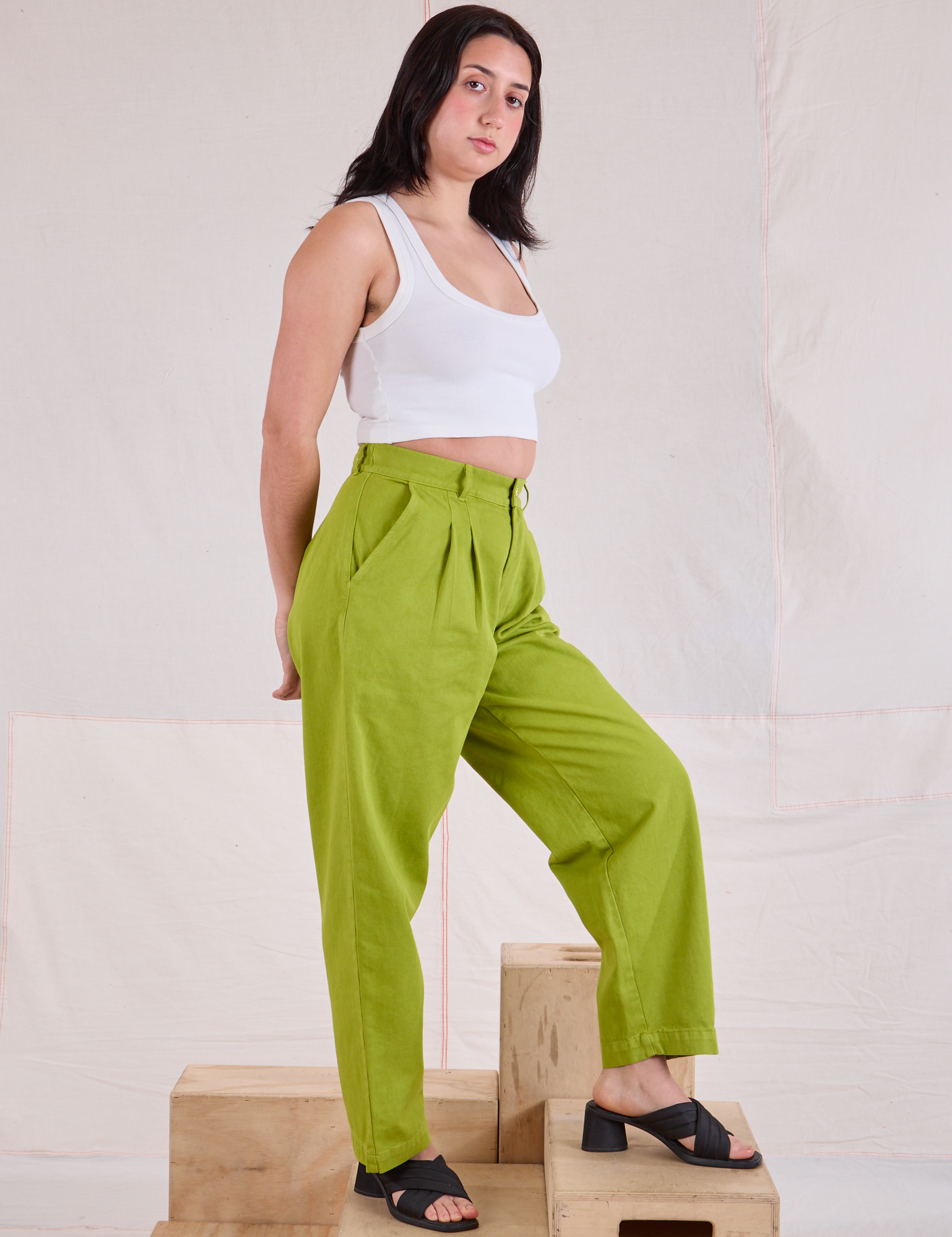 Angled front view of Heavyweight Trousers in Gross Green and Cropped Tank in vintage tee off-white