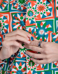 Close up of Alex buttoning up Cropped Overshirt in Quilt Print