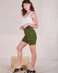 Side view of Railroad Carpenter Shorts in Summer Olive and Cropped Tank in Vintage Tee Off-White on Alex