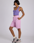 Side view of Longline Work Shorts in Lilac Purple and faded grape Cropped Tank on Kira