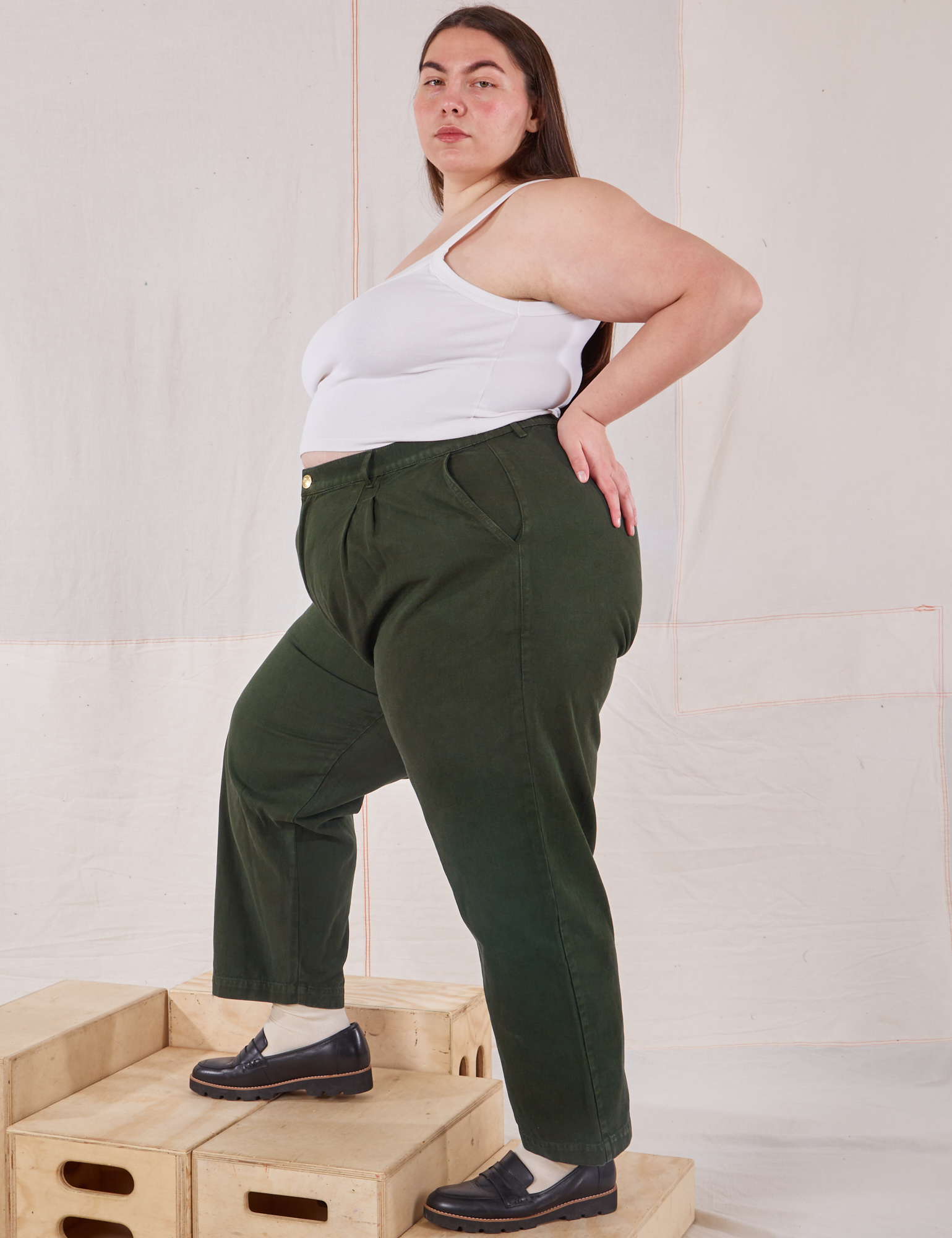 Side view of Heavyweight Trousers in Swamp Green and Cropped Cami in vintage tee off-white on Marielena