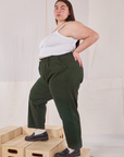Side view of Heavyweight Trousers in Swamp Green and vintage tee off-white Cami on Marielena