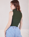 Sleeveless Essential Turtleneck in Swamp Green angled back view on Hana
