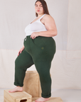 Side view of Rolled Cuff Sweat Pants in Swamp Green and Cropped Tank in vintage tee off-white on Marielena