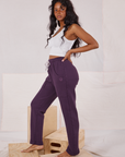 Side view of Rolled Cuff Sweat Pants in Nebula Purple and vintage off-white Cropped Tank on Kandia