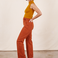 Work Pants in Burnt Terracotta side view on Soraya wearing spicy mustard Sleeveless Turtleneck