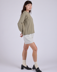 Side view of Pleated Trouser Shorts in Dishwater White and khaki grey Long Sleeve Burly Tee