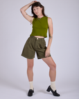 Alex is wearing Pleated Trouser Shorts in Surplus Green and Muscle Tee in Summer Olive