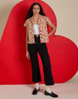 Shahana is wearing Hot Stuff Print Pantry Button-Up paired with black Western Pants