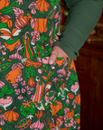 Juliet's hand is in the front pocket of Kitchen Collection Full Apron