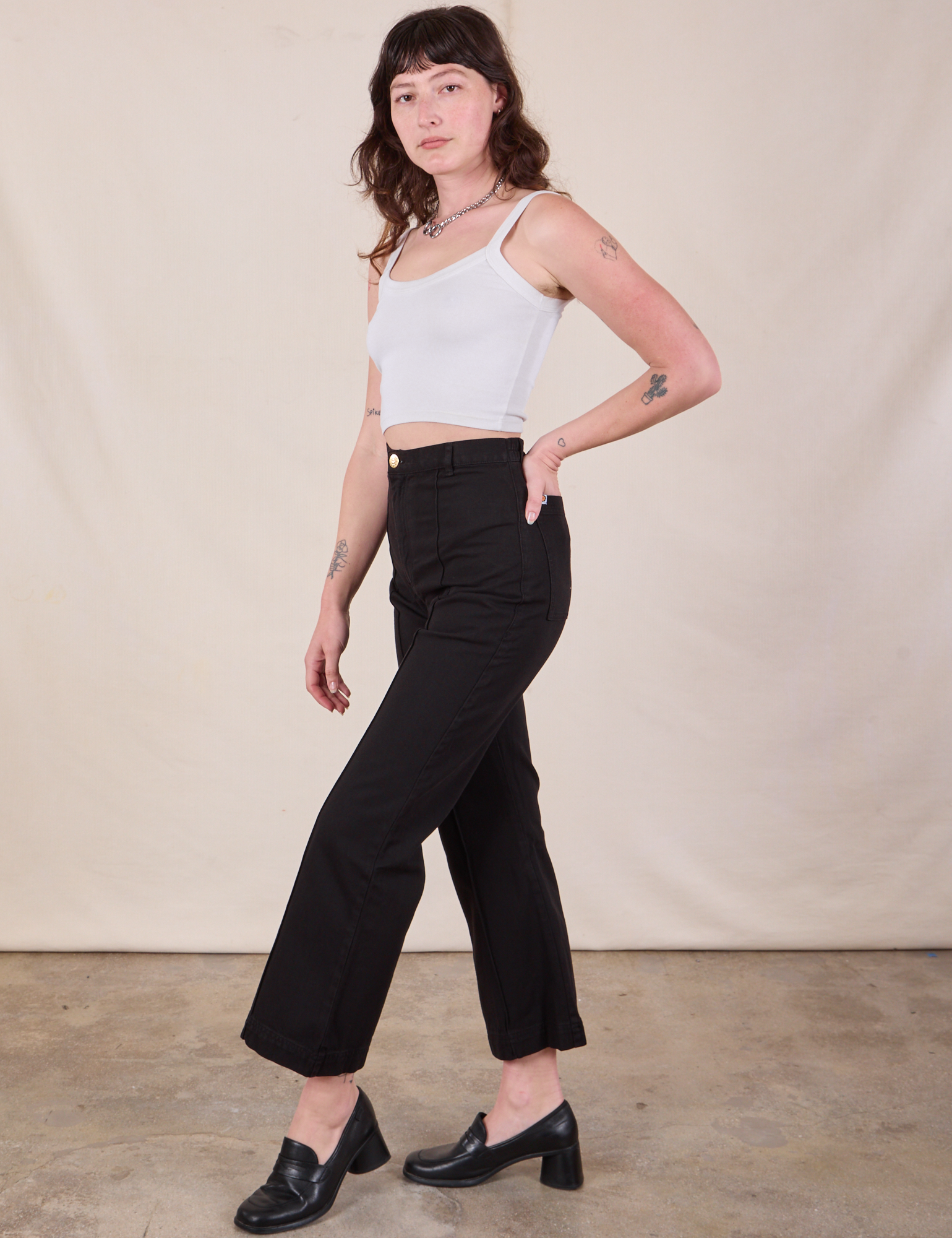 Side view of Western Pants in Basic Black and Cropped Cami worn by Alex