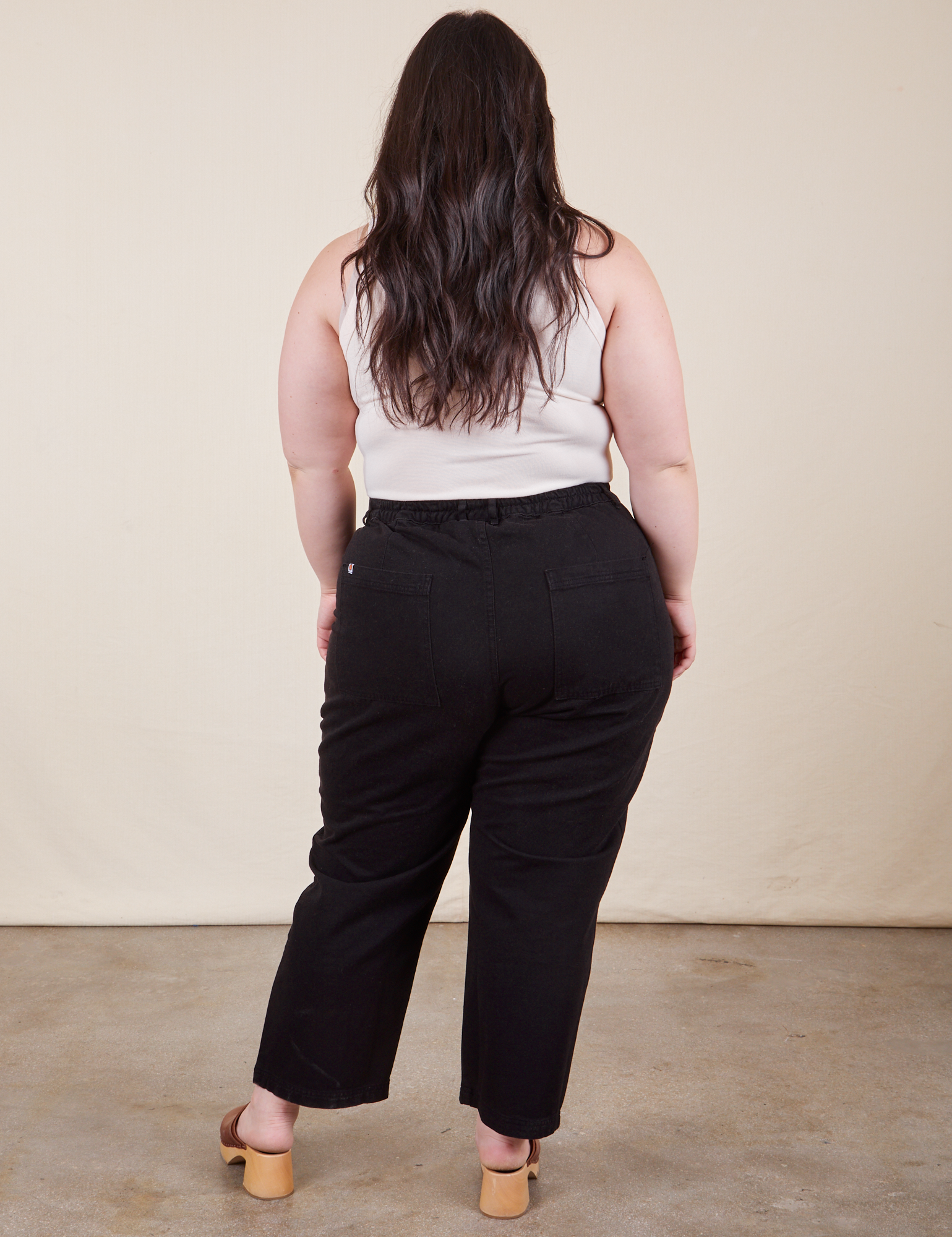 Work Pants in Basic Black back view on Ashley wearing Tank Top in vintage tee off-white