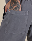 Close up of Jesse's hand in the back pocket of Work Pants in Washed Grey