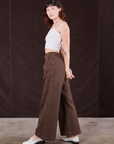 Side view of Overdyed Wide Leg Trousers in Brown and Cropped Cami in vintage tee off-white on Alex