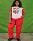 Morgan is wearing Anniversary Tee in Strawbaby and mustang red Work Pants