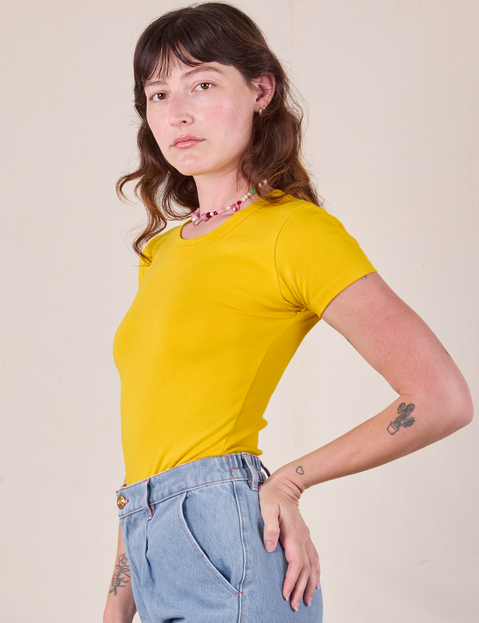 Baby Tee in Golden Yellow side view on Alex