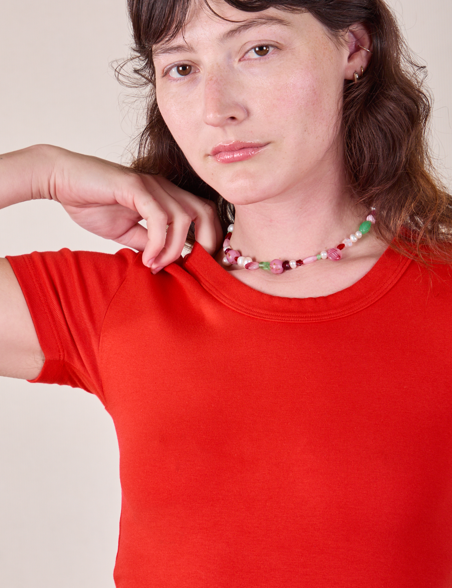 Close up of Baby Tee in Mustang Red on Alex