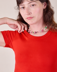 Close up of Baby Tee in Mustang Red on Alex