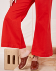 Bell Bottoms in Mustang Red pant leg close up on Alex