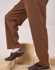 Side view of Checker Trousers in Brown & Black pant legs on Jesse