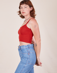 Side view of Cropped Cami in Mustang Red and light wash Frontier Jeans worn by Alex