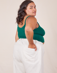 Angled back view of Cropped Cami in Hunter Green and vintage tee off-white Western Pants worn by Alicia.