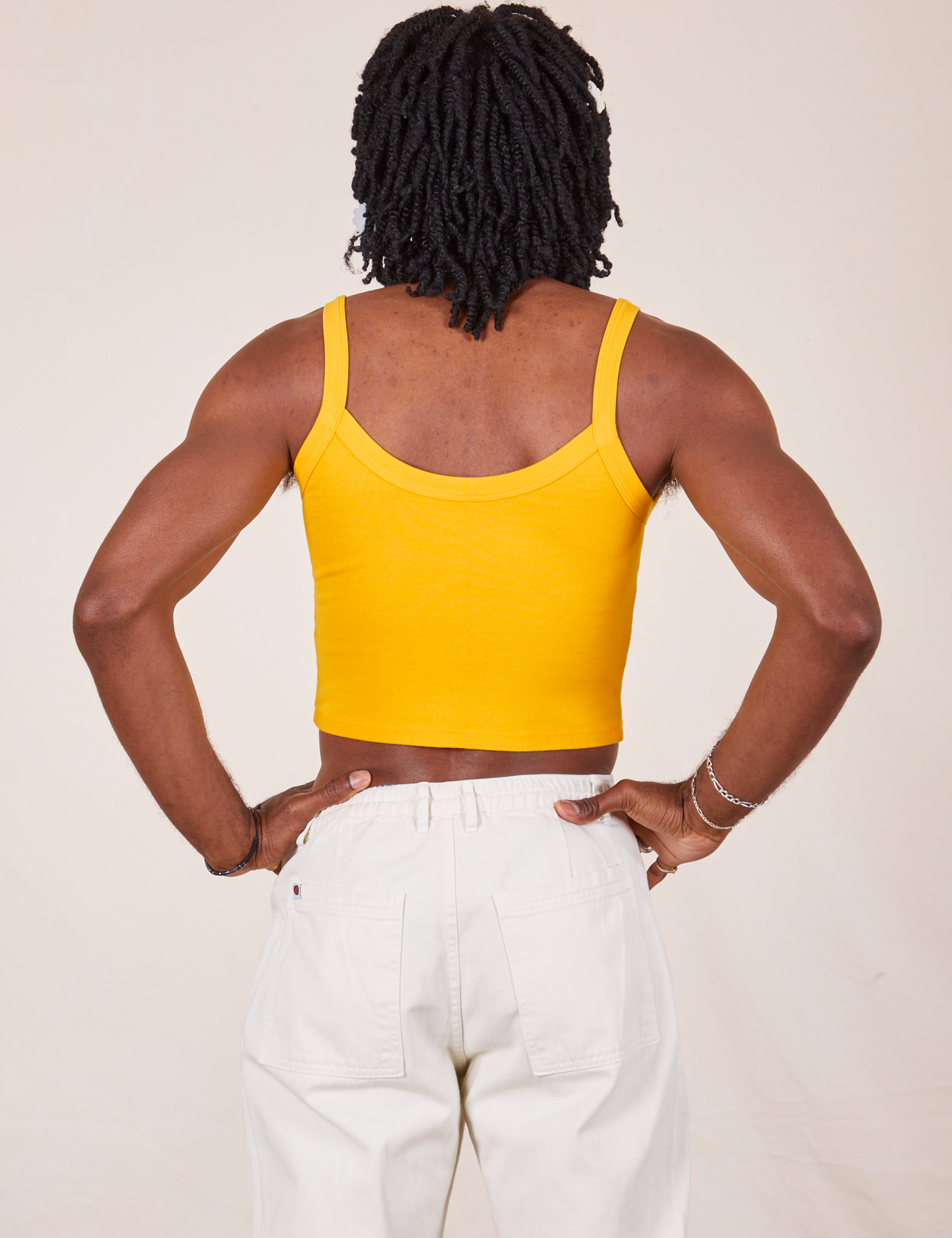 Back view of Cropped Cami in Sunshine Yellow and vintage tee off-white Western Pants worn by Jerrod