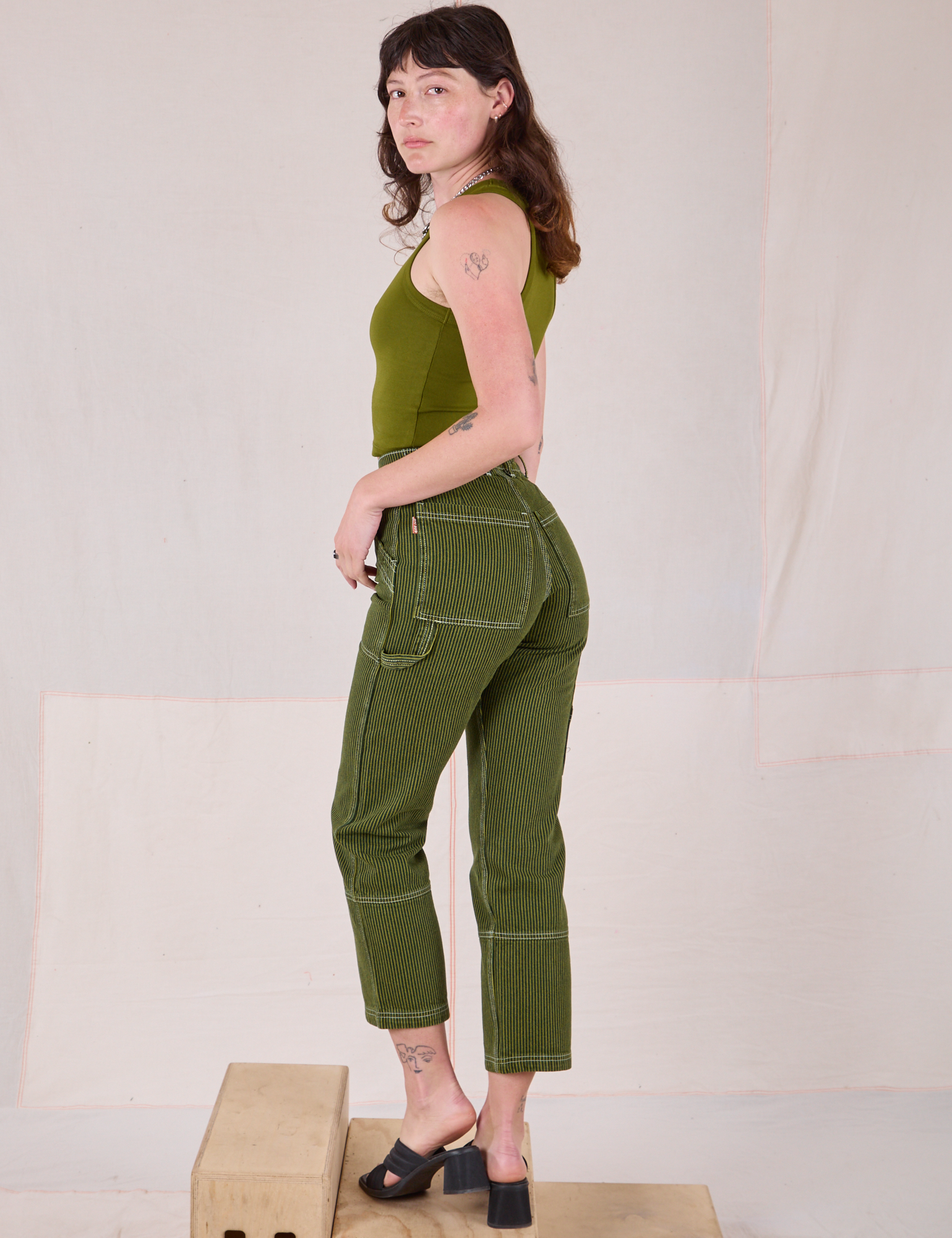 Angled back view of Railroad Carpenter Jeans in Summer Olive on Alex