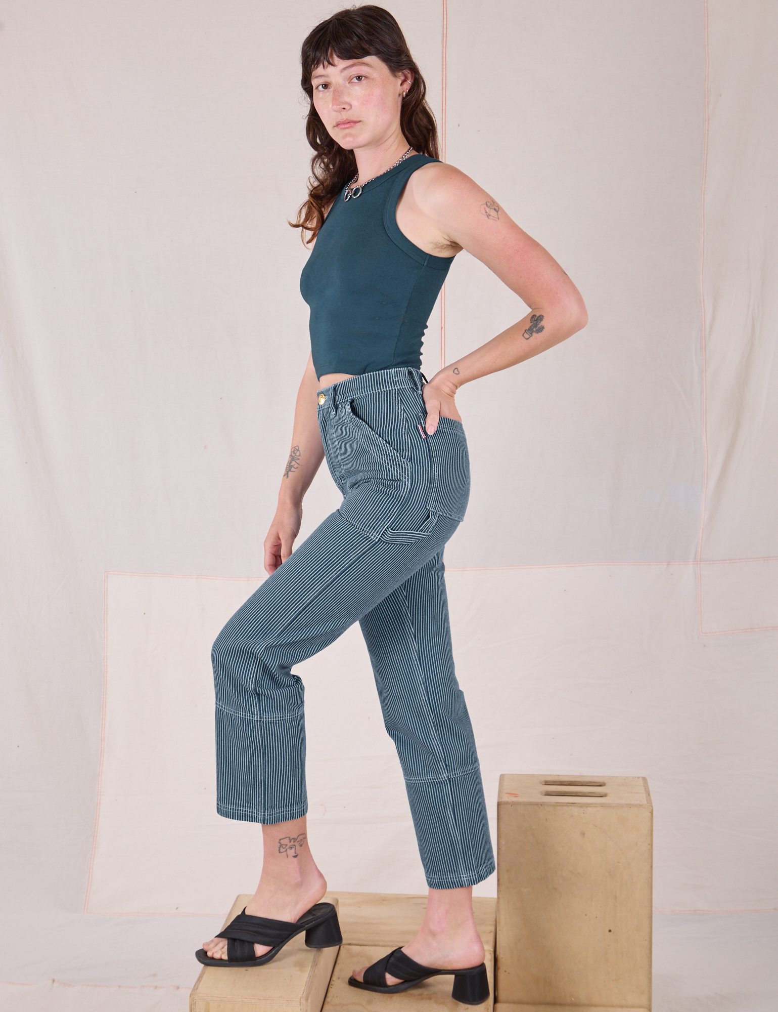 Side view of Railroad Carpenter Jeans in Baby Blue and marine blue Muscle Tee on Alex