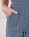 Close up of Alex's hand in the pocket of Carpenter Overalls in Railroad
