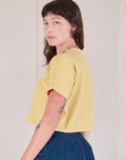 Cropped Burly Tee in Butter Yellow side view on Alex