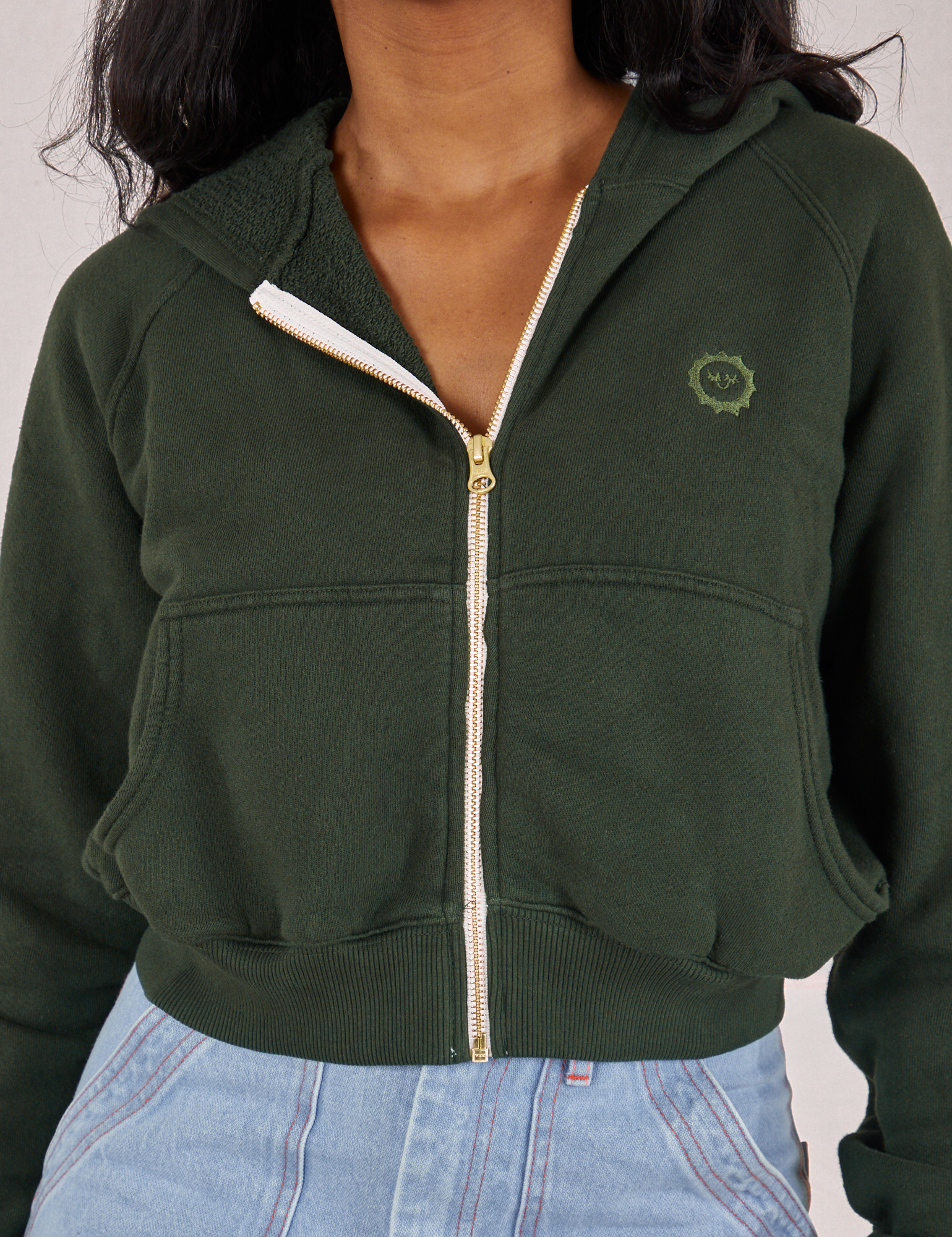 Close up of zipped Cropped Zip Hoodie in Swamp Green on Kandia