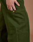 Close up of side leg pant pocket with Alex's hand tucked in