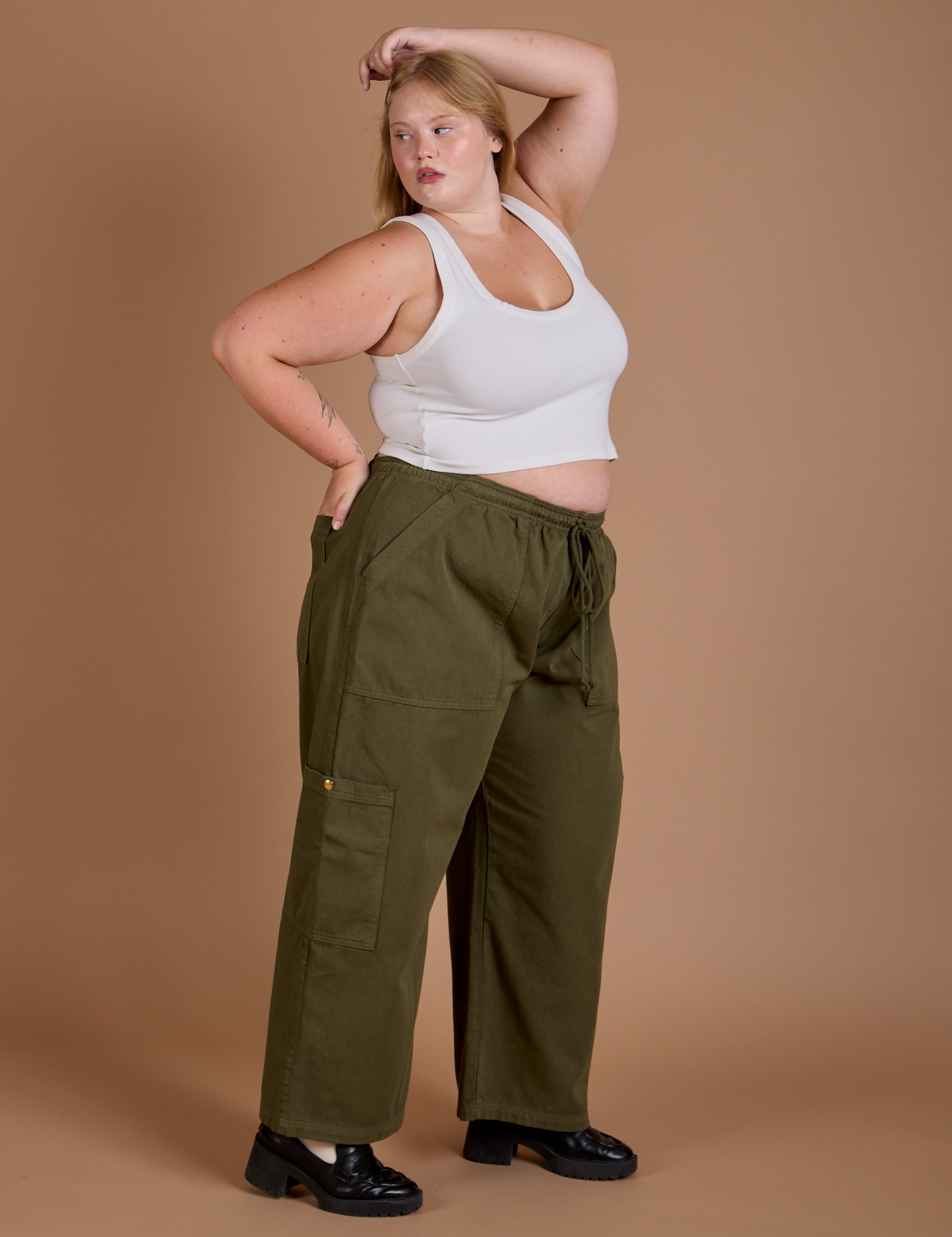 Side view of Drop Pocket Cargo Pants in Surplus Green and Cropped Tank in Vintage Tee White on Juliet